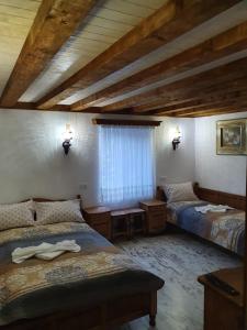 a bedroom with two beds and a window in a room at Kashtata s Paraklisa in Borowo