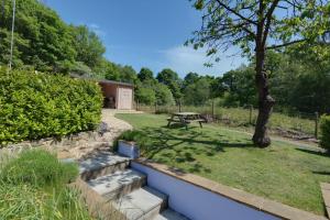 a garden with a picnic table and a tree at Lilac Cottage in Parkend