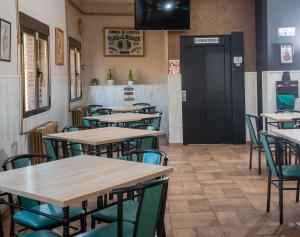 a restaurant with tables, chairs, and tables in it at Hostal El Trillero in Alcañiz