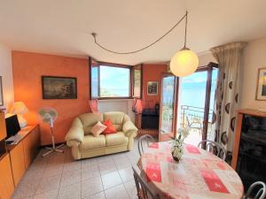 a living room with a chair and a table at Casa Valenti in Brenzone sul Garda +115 photos