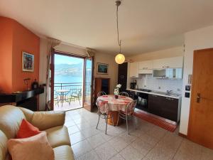 a living room with a table and a kitchen with a view at Casa Valenti in Brenzone sul Garda