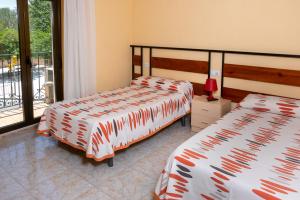 Postel nebo postele na pokoji v ubytování Hostal El Trillero