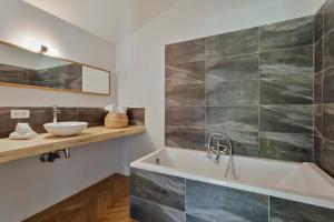 a bathroom with a sink and a bath tub at Scheldewegel Vakantiehuis in Schelderode +30 photos