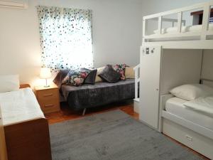 a bedroom with a couch and a bunk bed at Quinta da Gandarela in Tarouca