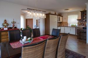 a kitchen and dining room with a table and chairs at Villa Eifelpalace am Nürburgring in Adenau
