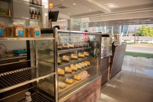 a bakery with a display case filled with donuts at Baan Suan Khun Ta and Golf Resort in Ubon Ratchathani