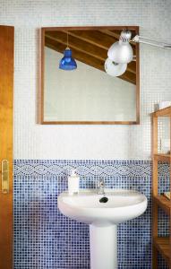 a bathroom with a white sink and a mirror at San Pedro Villoria in Pola de Laviana