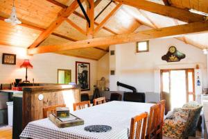 une salle à manger avec une table et une cuisine dans l'établissement La Tanière des druides, à Luzech