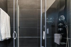 a bathroom with a shower with a glass door at Hotel Scigliano in Rossano +37 photos