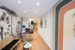 a hallway with a staircase with a mural on the wall at Hôtel de la Plage in Sète