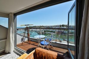 a balcony with a view of the water at Beacon House B&B Brixham in Brixham