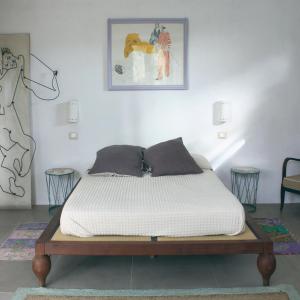 a bed in a room with a white mattress at La Grechea Boutique B&B in Casale Alxi