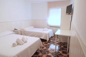 Postel nebo postele na pokoji v ubytování Hostal Jaufil
