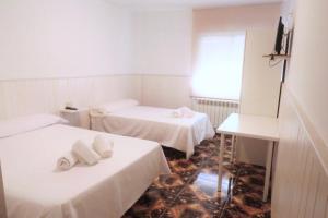 Postel nebo postele na pokoji v ubytování Hostal Jaufil