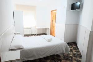 Postel nebo postele na pokoji v ubytování Hostal Jaufil