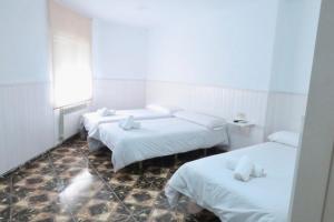 Postel nebo postele na pokoji v ubytování Hostal Jaufil