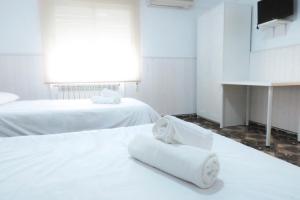 Postel nebo postele na pokoji v ubytování Hostal Jaufil