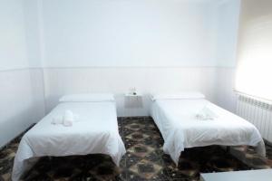 Postel nebo postele na pokoji v ubytování Hostal Jaufil