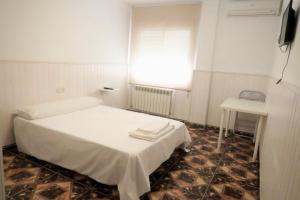 Postel nebo postele na pokoji v ubytování Hostal Jaufil
