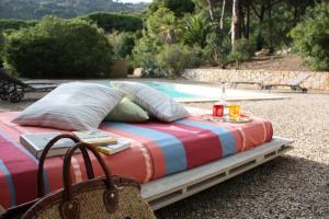 a bed sitting in front of a swimming pool at La Grechea Boutique B&B in Casa Alzi