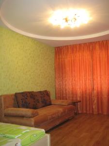a living room with a couch and a curtain at Комфортная 1-комнатная Новопречистенская 1 in Cherkasy