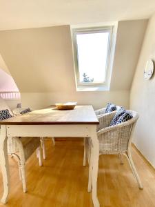 a dining room with a table and two chairs at Ferienwohnung Hochdorfer Garten in Tating