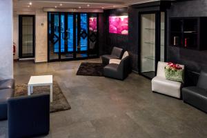 a lobby with couches and chairs and a table at Hotel Scigliano in Rossano
