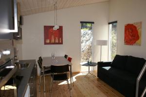 a living room with a table and a couch at Fjordlyst Camping & Cottages in Aabenraa