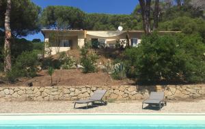 a house with two chairs in front of a pool at La Grechea Boutique B&B in Casa Alzi