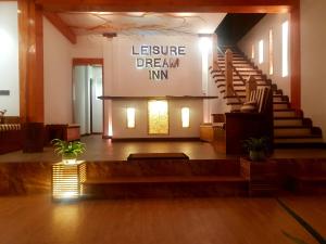 a lobby with stairs and a sign that reads lecture dream inn at Leisure Dream Inn in Ella
