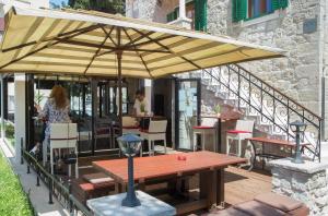 
a patio area with tables, chairs and umbrellas at Hotel Villa Diana in Split
