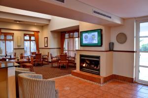 a hotel room with a fireplace and a tv at Town Lodge George in George