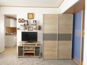 a living room with a tv and a sliding glass door at Ferienwohnung Jakob in Bremerhaven