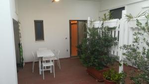 a patio with a table and chairs and a door at MandorleOlio in Polignano a Mare