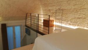 a bedroom with a bed and a wooden shelf at MandorleOlio in Polignano a Mare