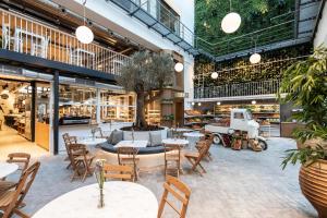a restaurant with tables, chairs, and tables in it at Ergon House in Athens