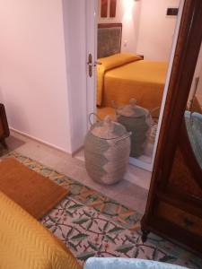 a room with a bed and two baskets on the floor at MandorleOlio in Polignano a Mare