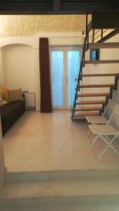 a living room with a staircase and a couch at MandorleOlio in Polignano a Mare