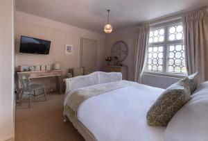 Een bed of bedden in een kamer bij The Ship At Dunwich