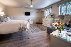 a bedroom with a bed and a living room at The Ship At Dunwich in Dunwich