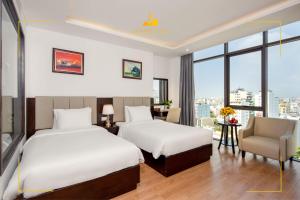 Rúm í herbergi á Golden Line Hotel Danang