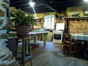 a kitchen with a table and a stove top oven at la maison du bonheur chez Yann HUMBLET in Moulis