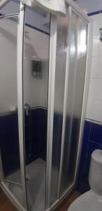
a shower stall with a glass door at Posada de Serrada in Serrada de la Fuente
