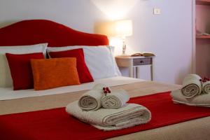 a bedroom with a bed with towels on it at Residence Ferraud in Pinerolo