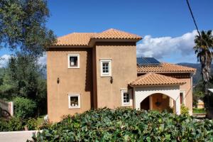 a house with a tile roof at Traditional Villa Mandola in Kefallonia