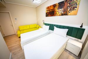 two beds in a room with a yellow couch at Villa Abiori in Ksamil +52 photos