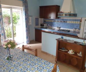 a kitchen with a table and a counter top at casa aurora in Calatabiano