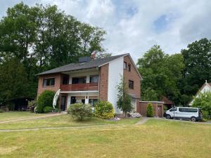 a house with a car parked in front of it at Apartment Gohfeld in Löhne