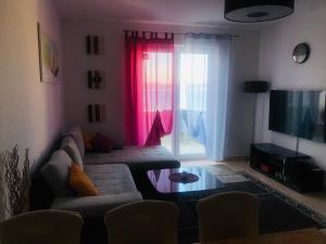 a living room with a couch and a flat screen tv at Apartment Svetlana in Selce