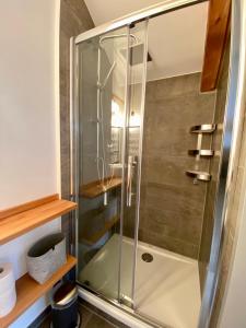 a shower with a glass door in a bathroom at Ferienwohnung Röthenbach in Oberaudorf